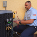 Grande Aire technician performing a seasonal tune-up on an AC unit