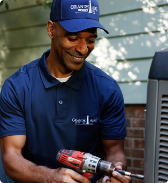 Grande Aire employee working on an HVAC unit